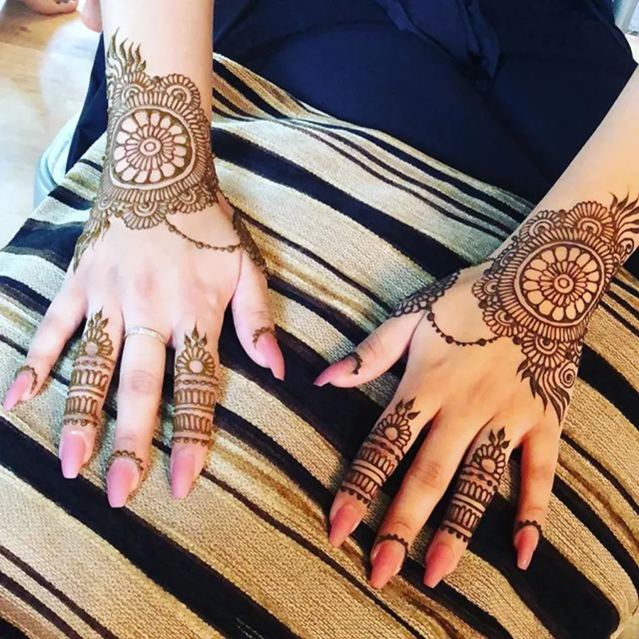Mandala-style party henna on a guest at an event