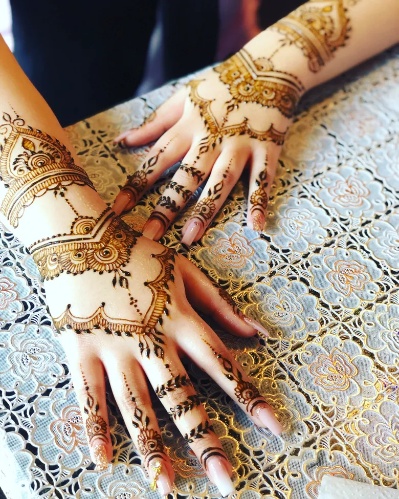 Detailed party mehndi on a guest's hands