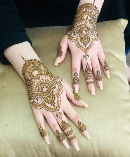 Floral party henna design on a hand
