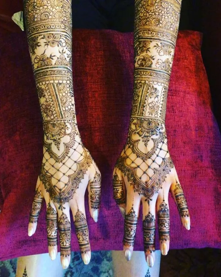 Detailed engagement mehndi on a bride's hands