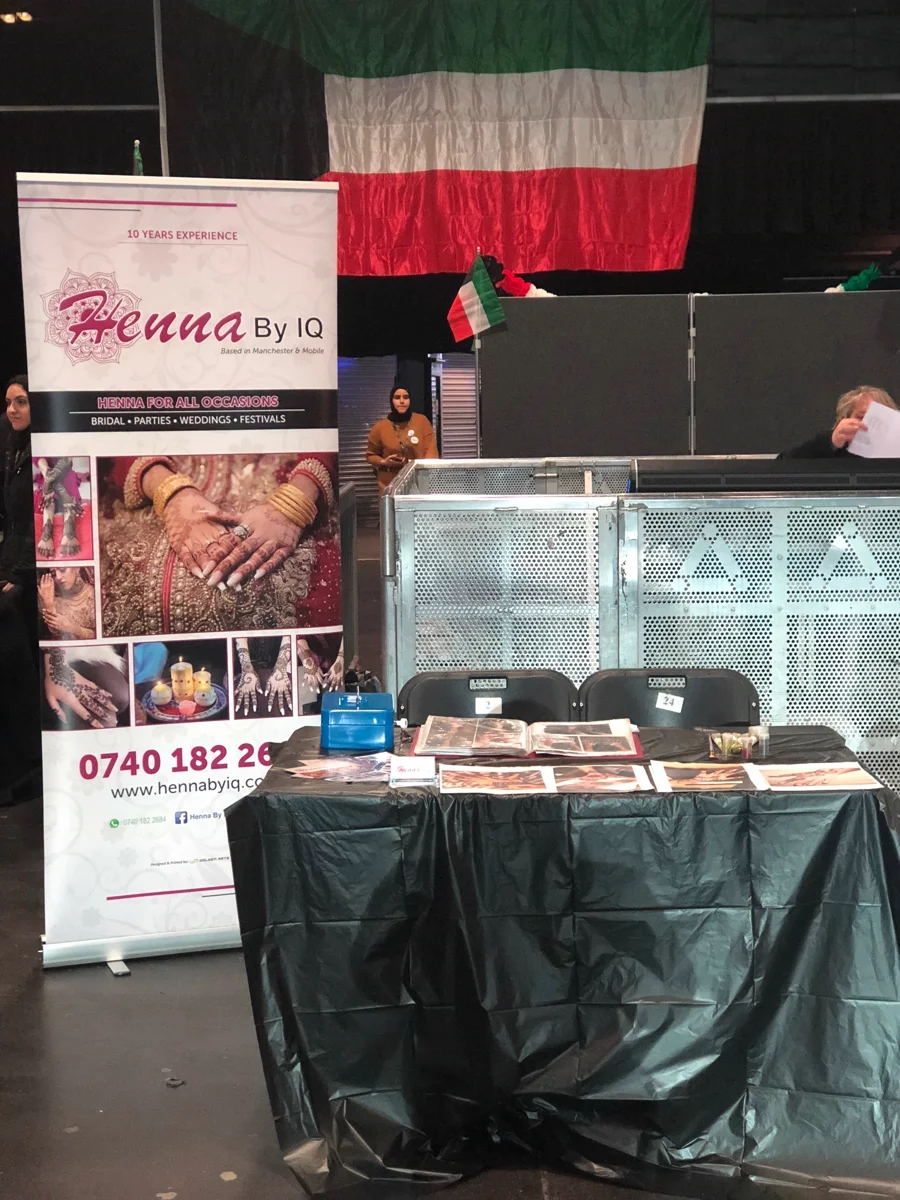 Professional Henna By IQ booth setup at an event