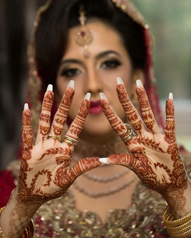 Bridal hands with detailed mehndi design